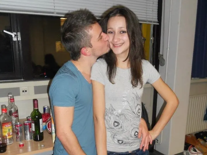 Olya and Andrei at a student party, Andrei kissing Olya on the cheek